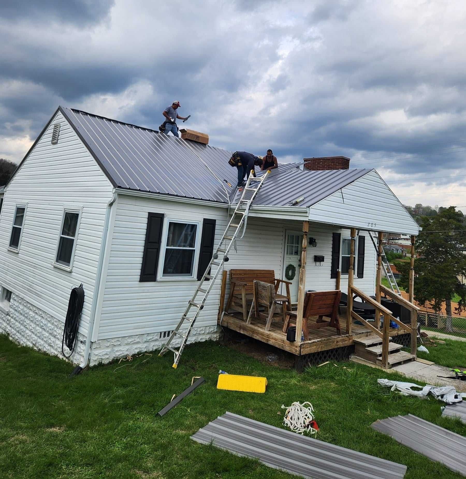 Roofing contractor installing asphalt shingles with a pneumatic nail gun