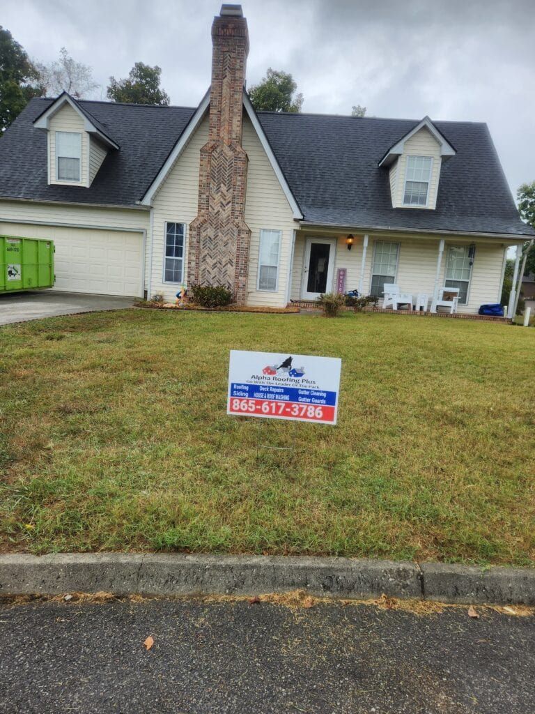 House with large stone chimney and lawn sign for sale in front yard