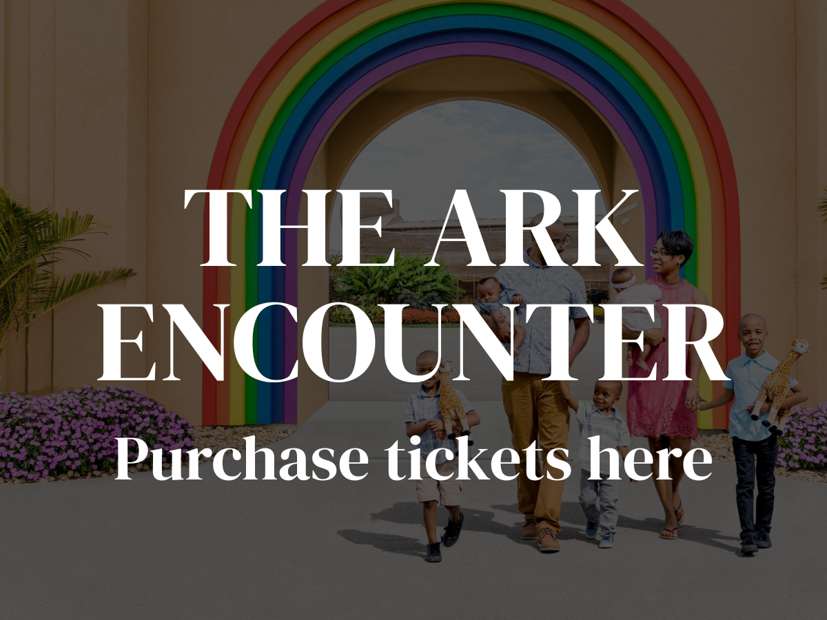 “The Ark Encounter” sign with rainbow arch and people walking toward a purchase tickets booth
