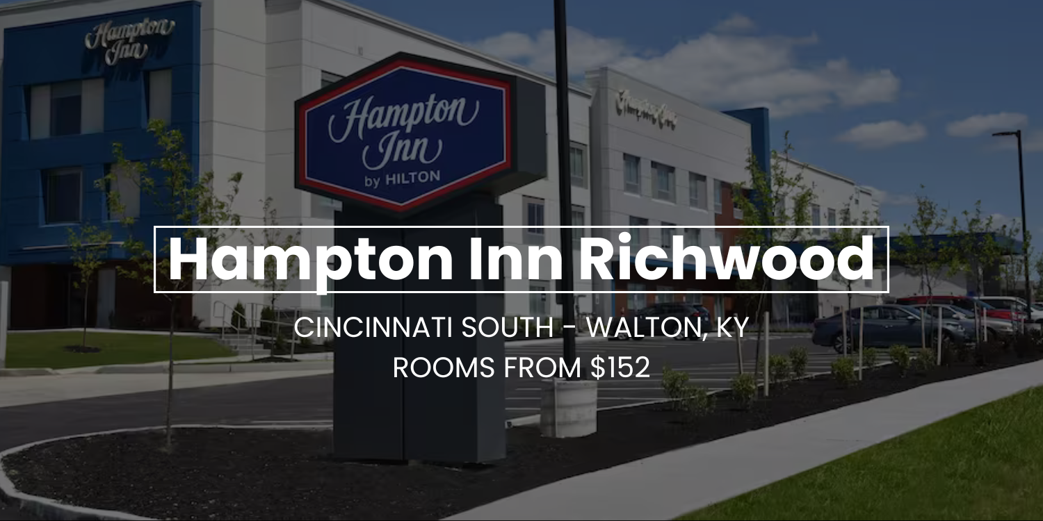 Hampton Inn Richwood hotel exterior with sign, blue sky, and text advertising rooms from $182.