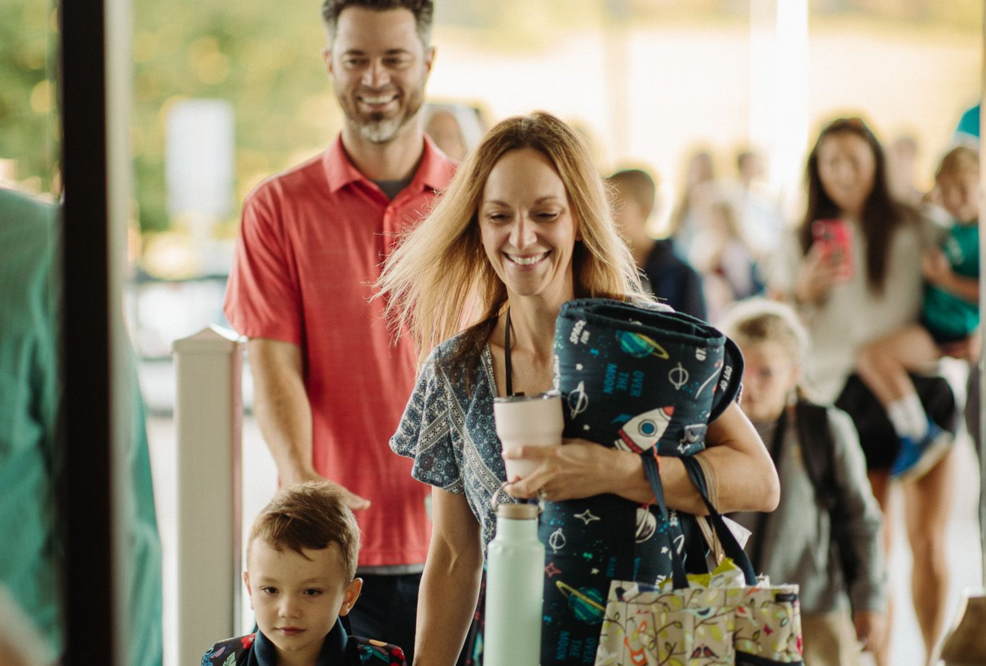Smiling family with shopping bags in a store checkout line