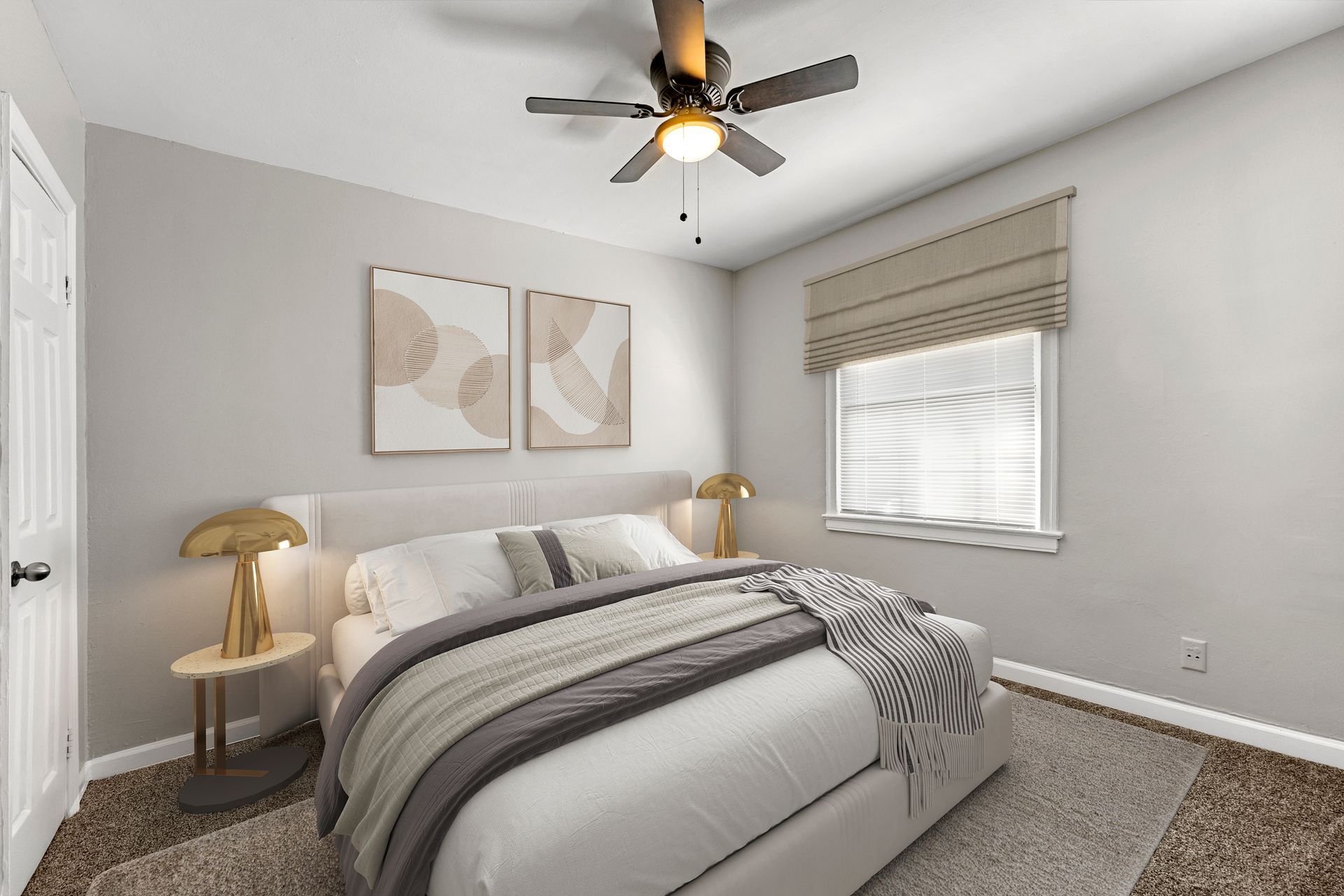 Bright bedroom with gray bedding, two wall art panels, a ceiling fan, and a window with blinds.