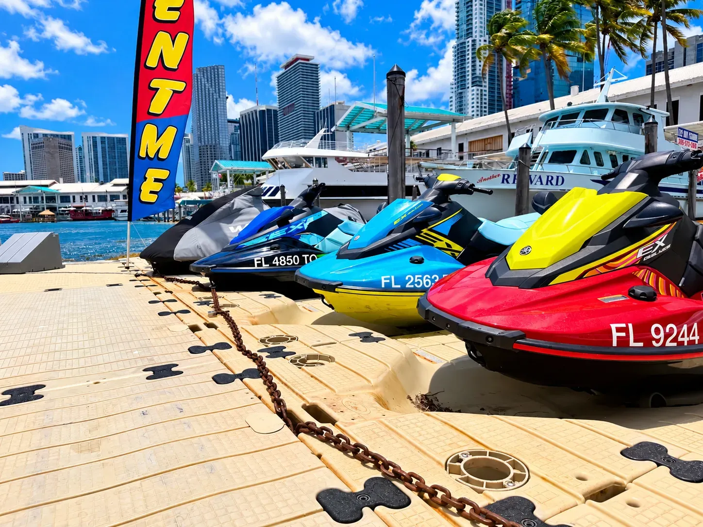 Biscayne Bay jet ski rentals lined up at Bayside Marina with Downtown Miami waterfront views