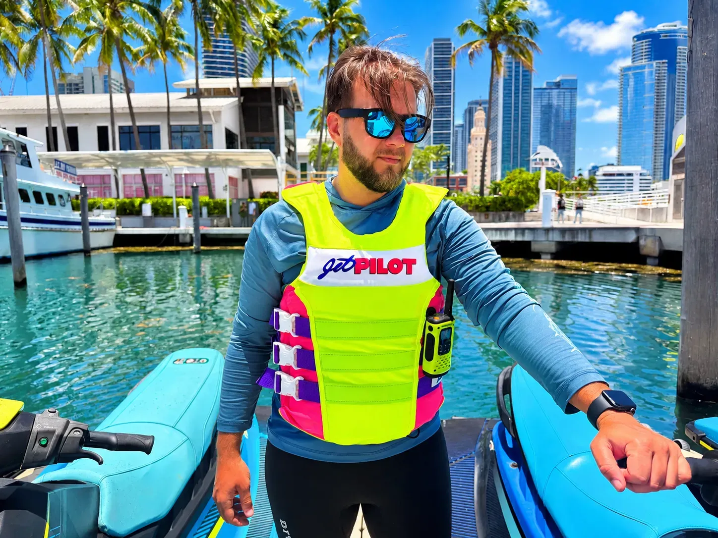 Jet ski rental tour guide in Bayside Marketplace standing with jet skis at the marina.
