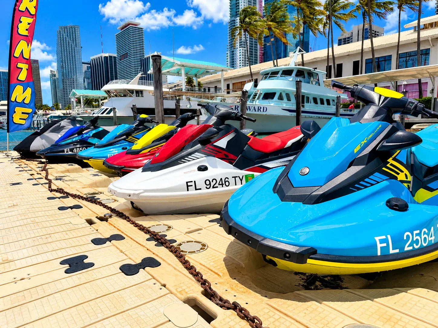 Jet ski rentals in Miami lined up at Bayside Marina with Downtown Miami and waterfront views
