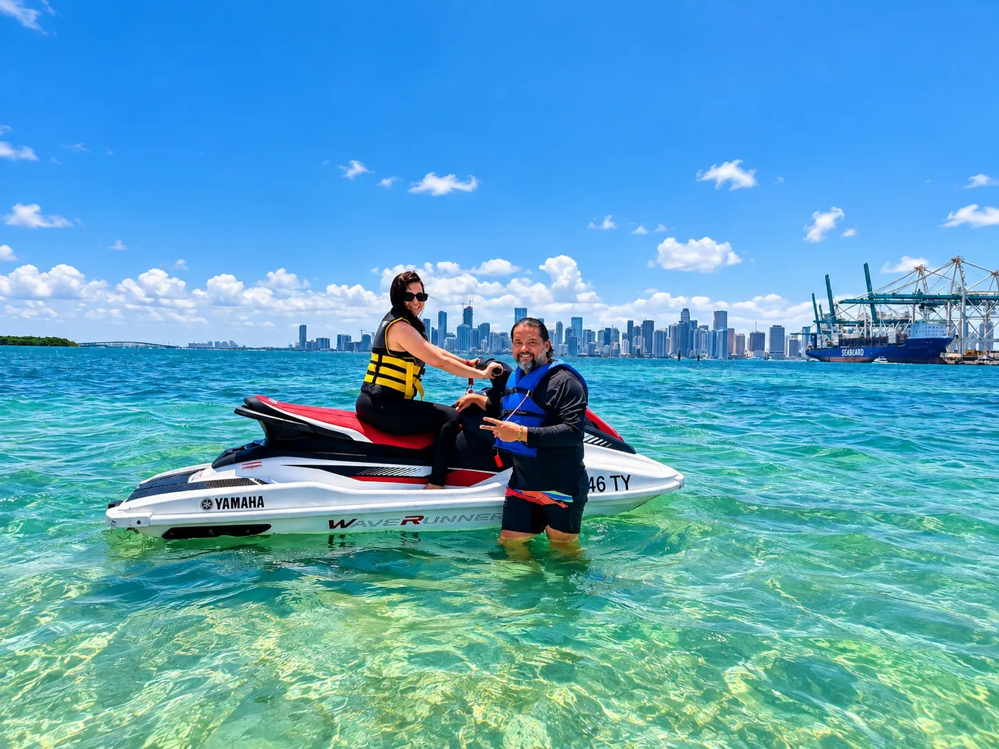 Couple enjoying a Miami guided jet ski rental tour from Bayside Marketplace with the Downtown Miami skyline in the background