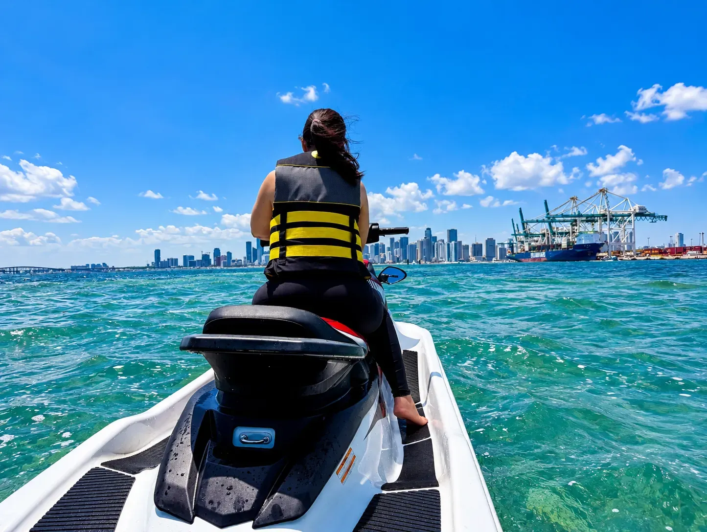 Guest enjoying Miami guided jet ski rentals on Biscayne Bay with the Downtown Miami skyline ahead