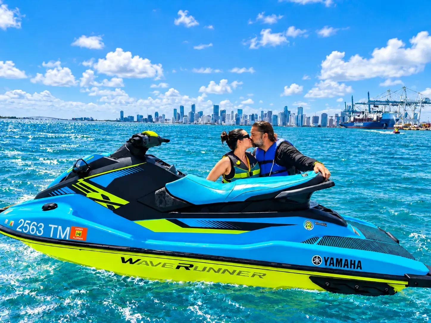 Couple enjoying Miami guided jet ski tours with the Downtown Miami skyline in the background