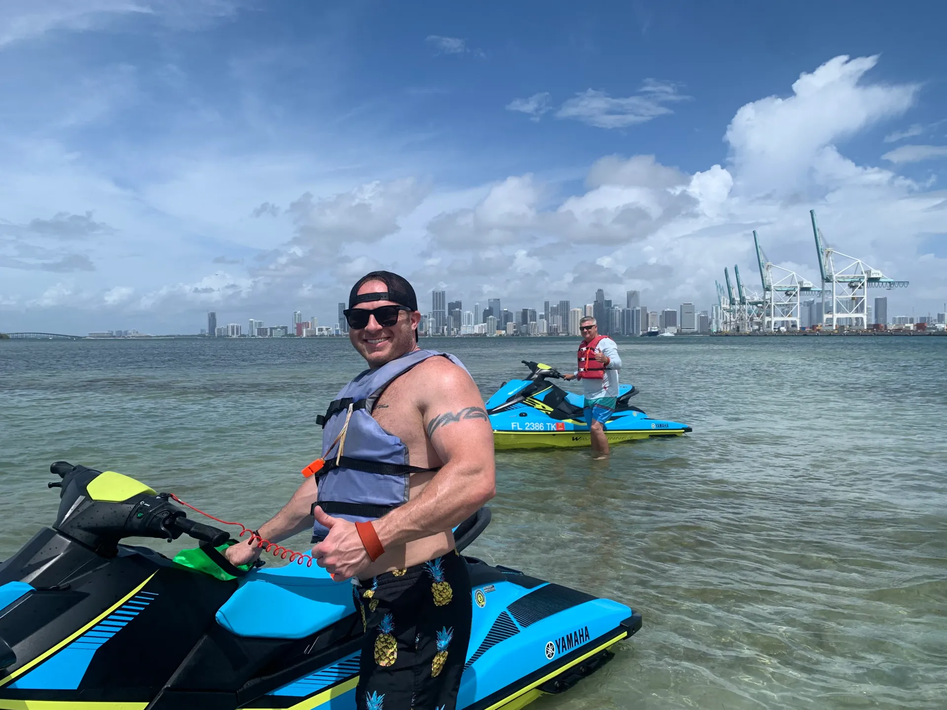 Guests enjoying a Miami jet ski guided tour near Fisher Island sandbar with the Miami skyline in the background