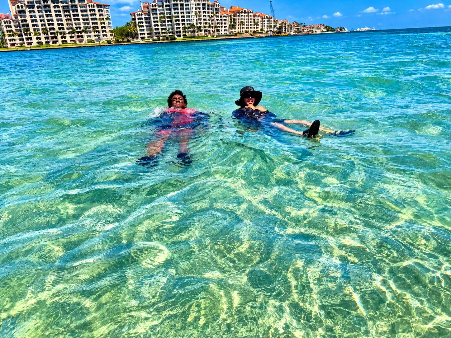 Riders relaxing and swimming during a Miami jet ski sandbar stop near Fisher Island