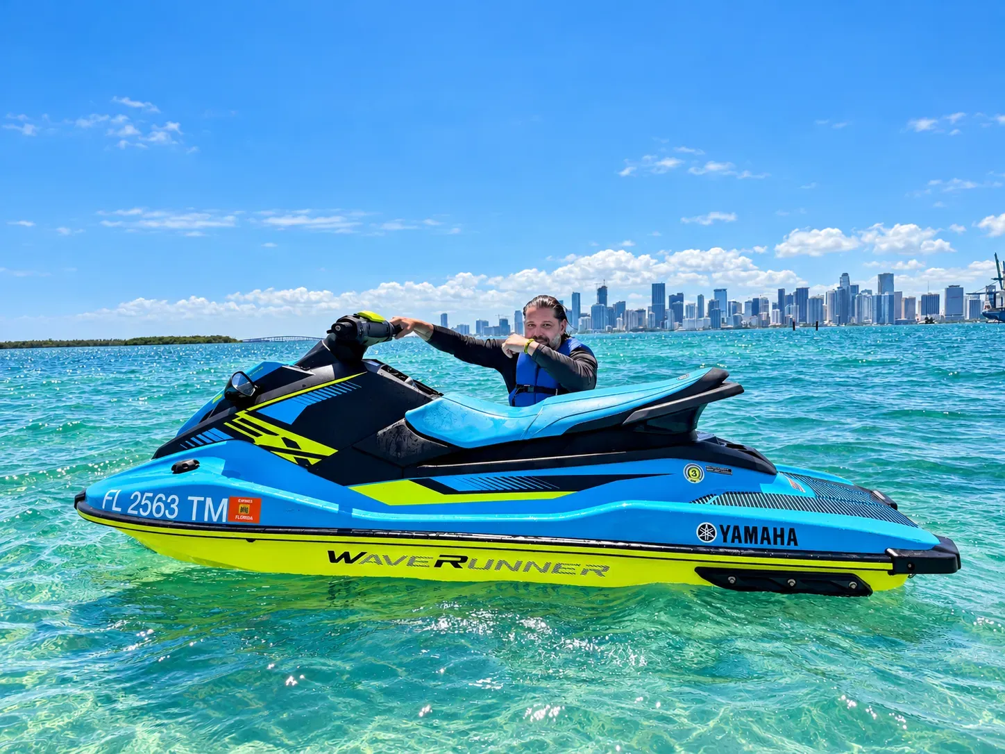Man posing for a photo during Miami Jet Ski Tours on Biscayne Bay with the Downtown Miami skyline in the background
