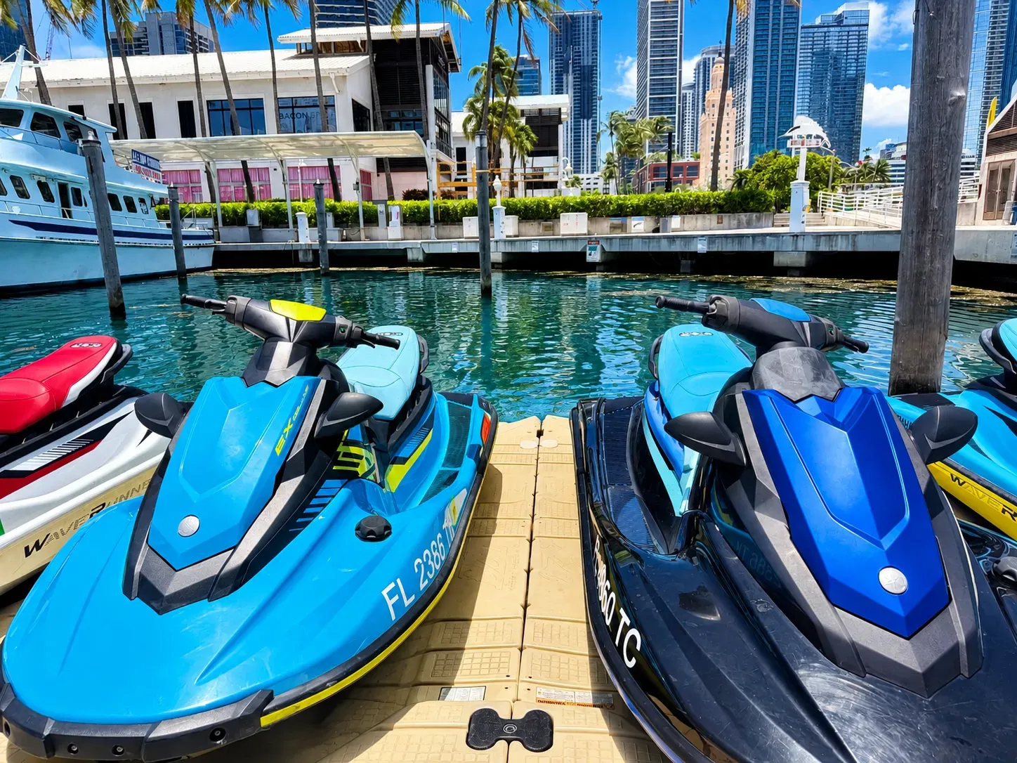 Rental jet skis in Miami lined up along Biscayne Bay with waterfront skyline views