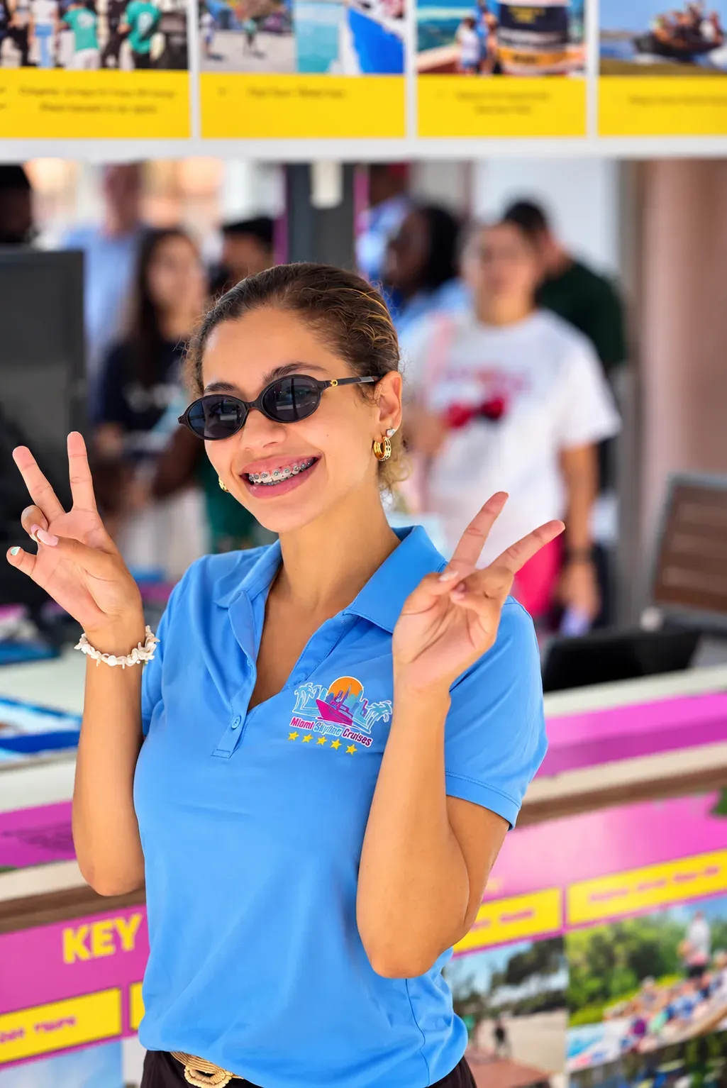 Smiling Skyline Cruises Miami staff member at the Bayside Marketplace tour kiosk, 401 Biscayne Blvd, Miami, FL 33132