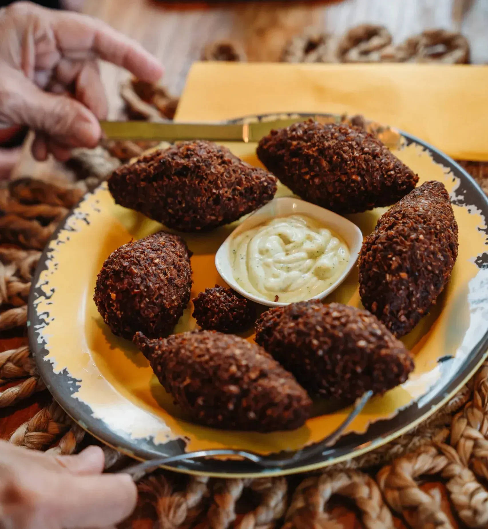 A plate of food with a dipping sauce on it