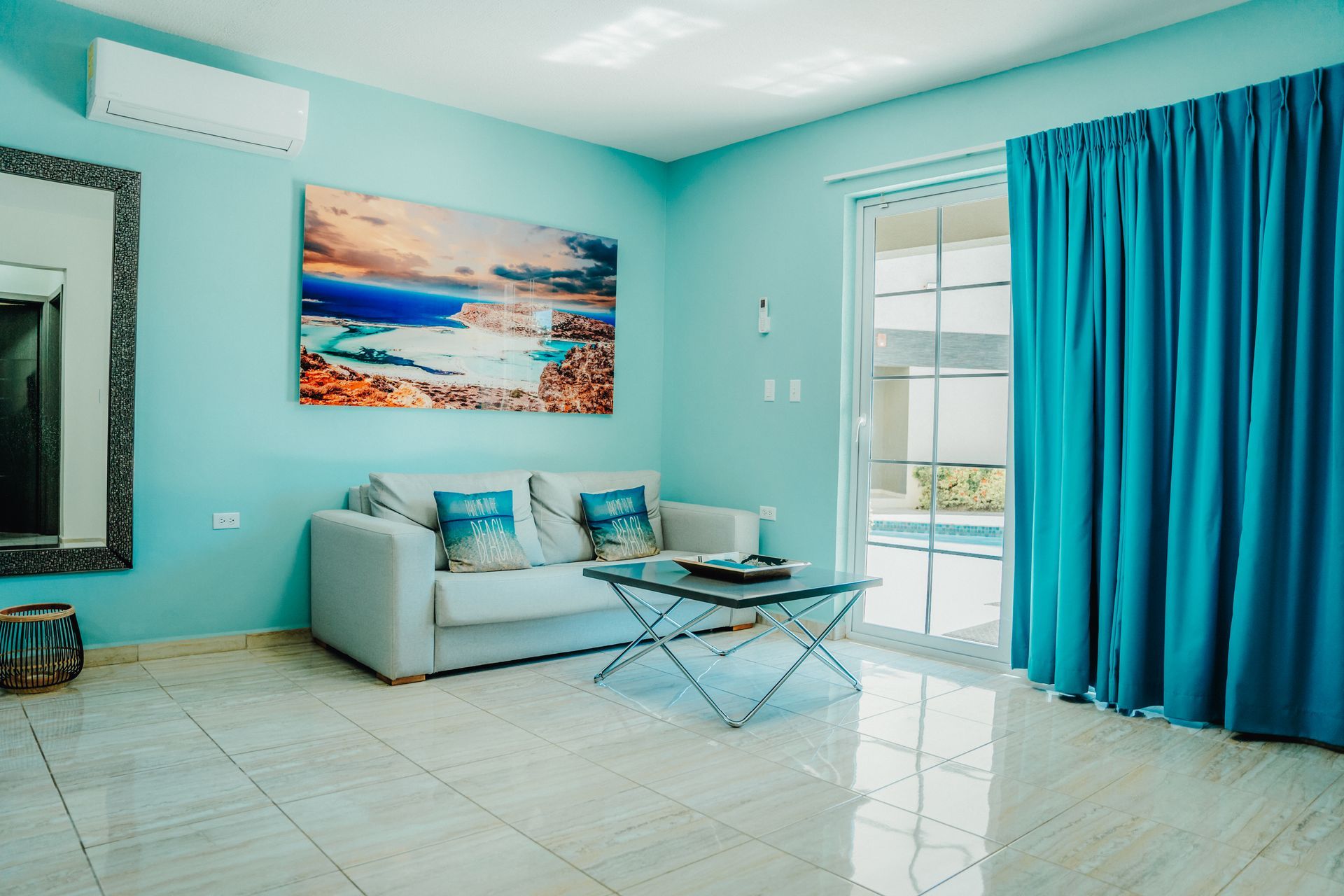 A hotel room with two beds and a blue rug.