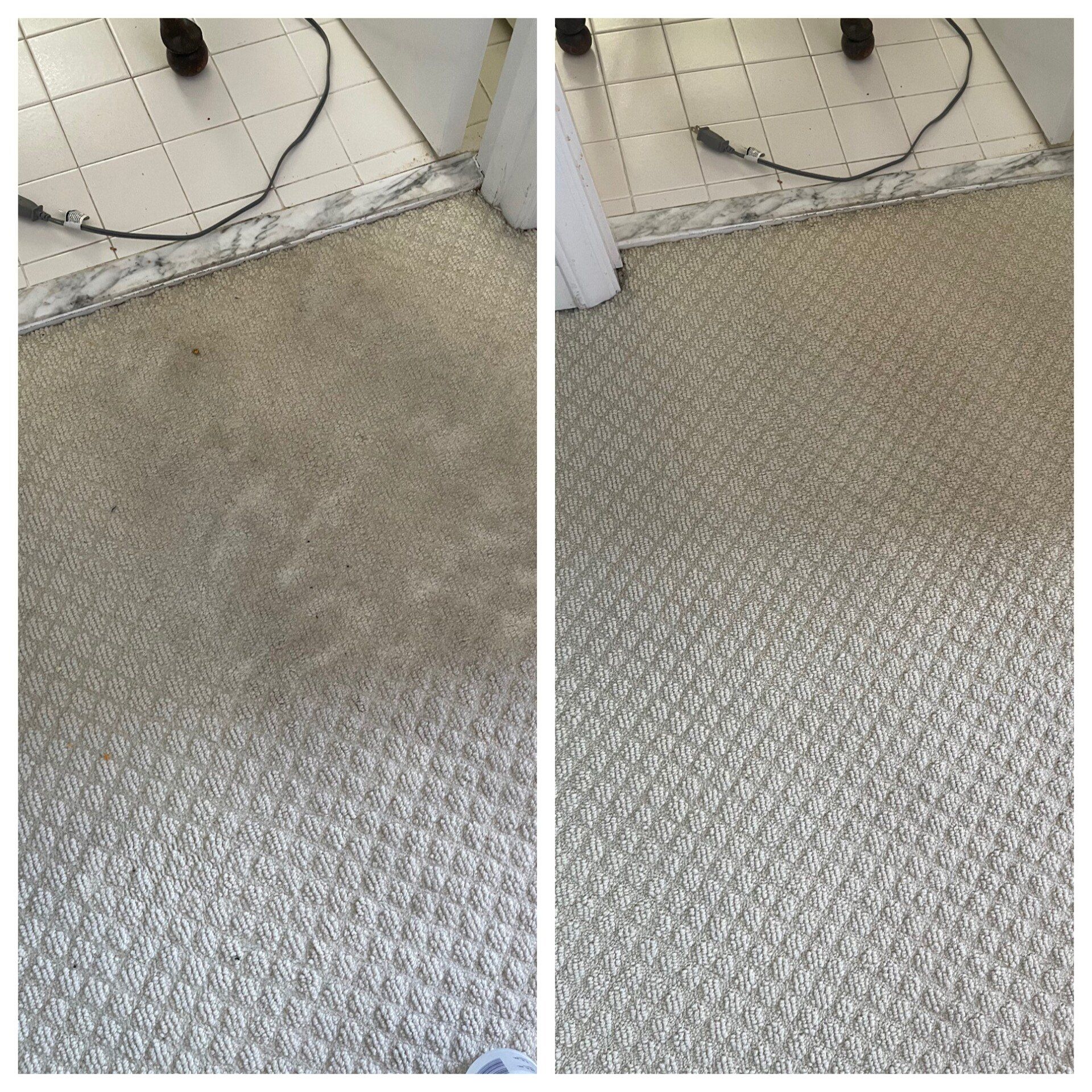 Carpet cleaning service in Durham, NC, close-up of textured gray floor tiles beside a white wall and doorway.
