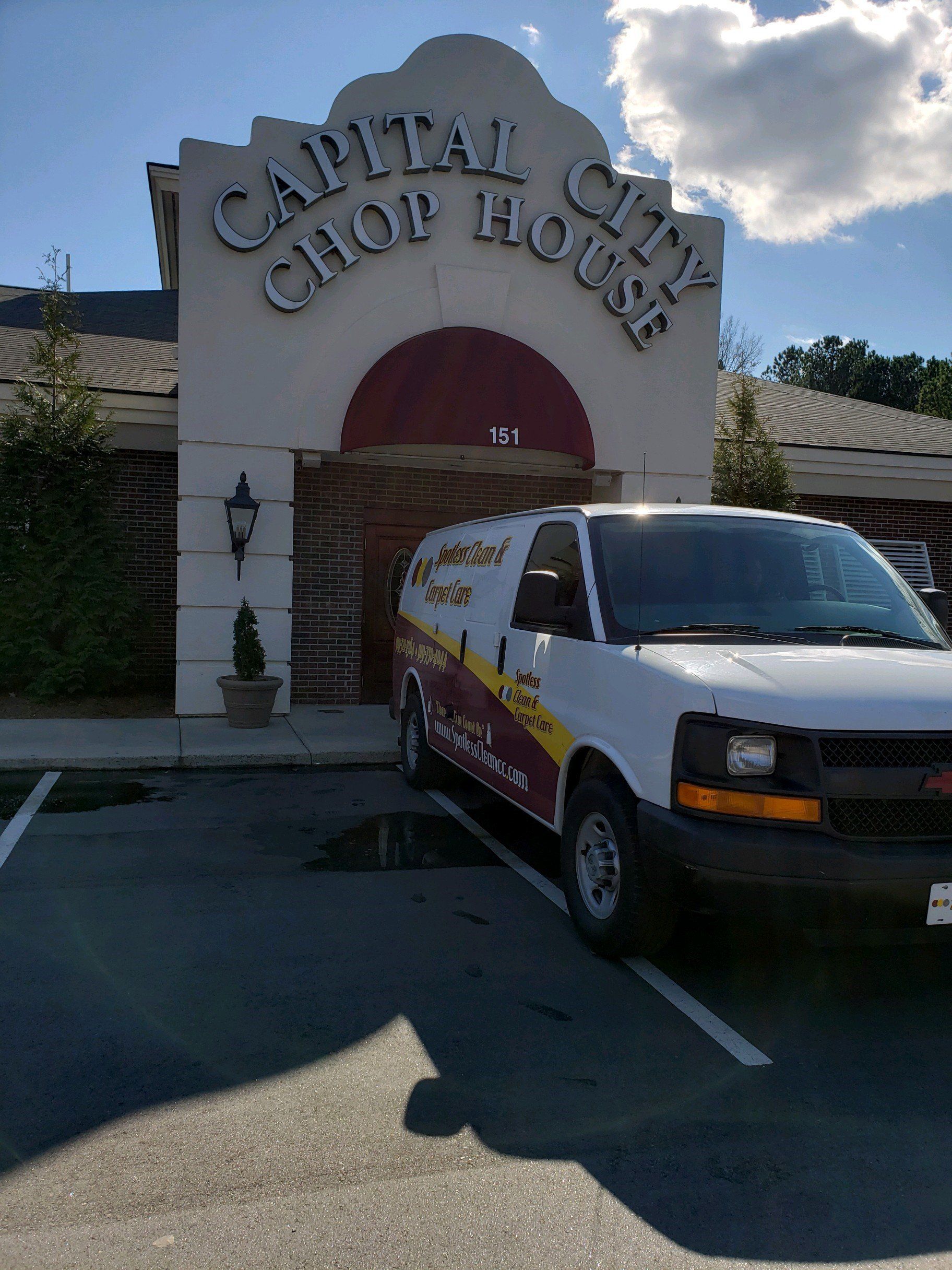 Carpet cleaning service in Durham, NC, central Club House entrance with a white delivery van parked in front