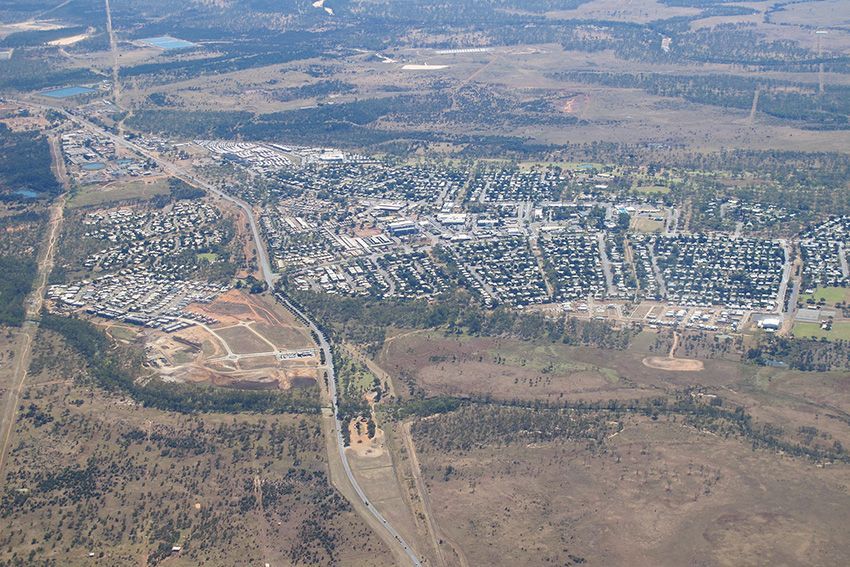 An Aerial View of a Small Town Surrounded by Trees and Fields — Ace Wholesale Trophies & Engraving In Moranbah, QLD