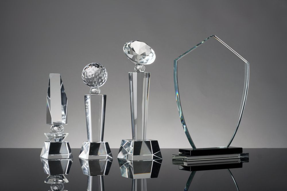 Three Silver Trophies Are Sitting On Top Of Each Other On A Table — Ace Wholesale Trophies & Engraving In Bakers Creek, QLD