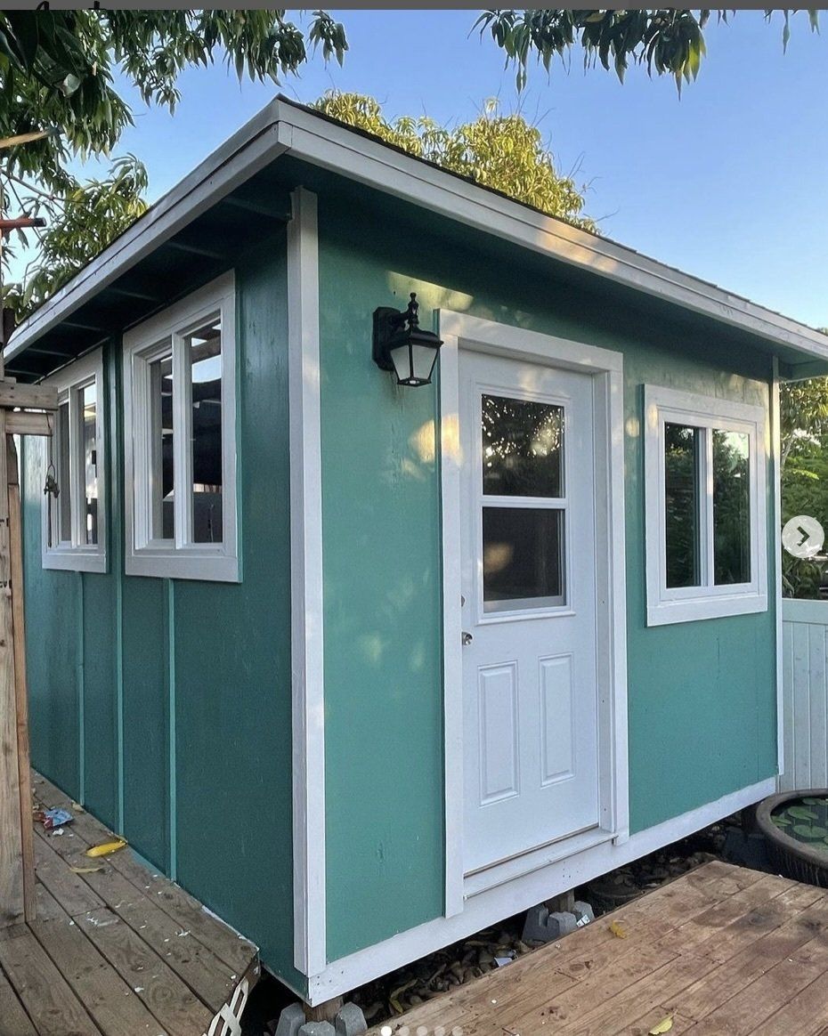 Studio Shed with windows and door and blue green exterior