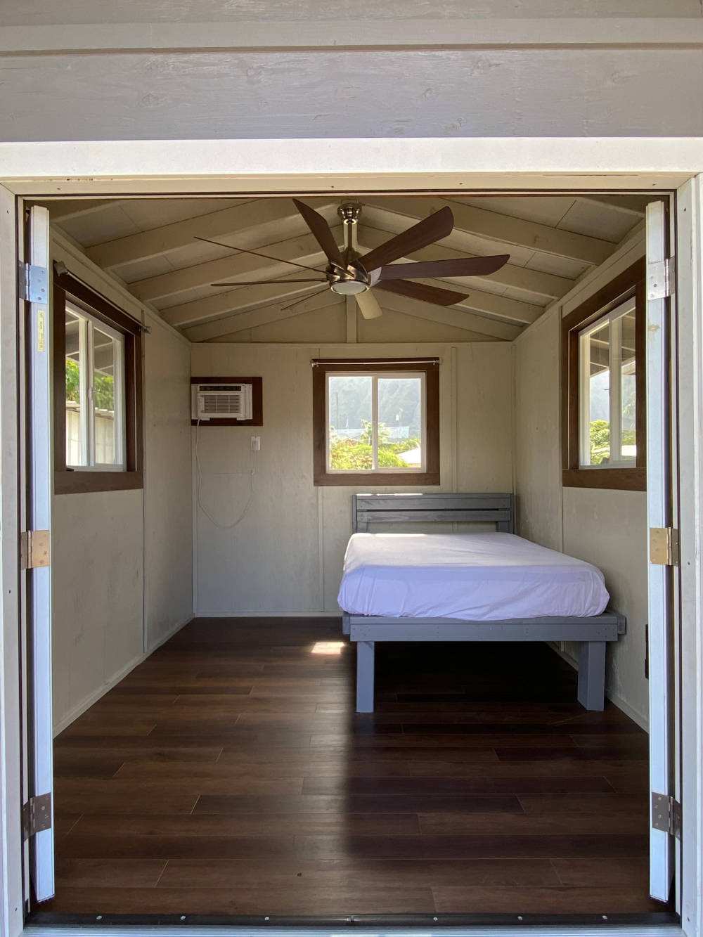 Studio Shed interior with custom wood decor and ceiling fan