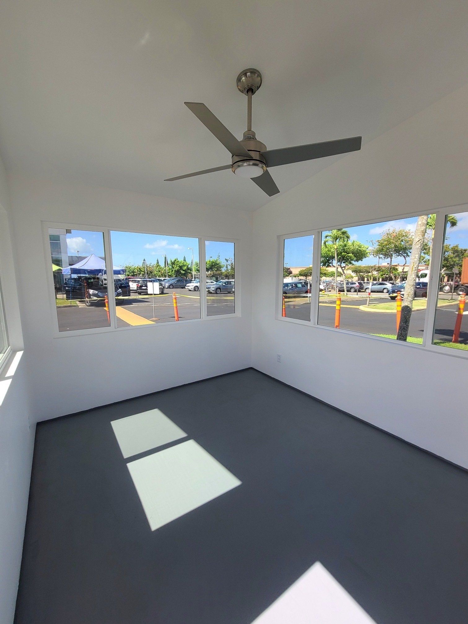 Studio Shed interior with custom windows and ceiling fan