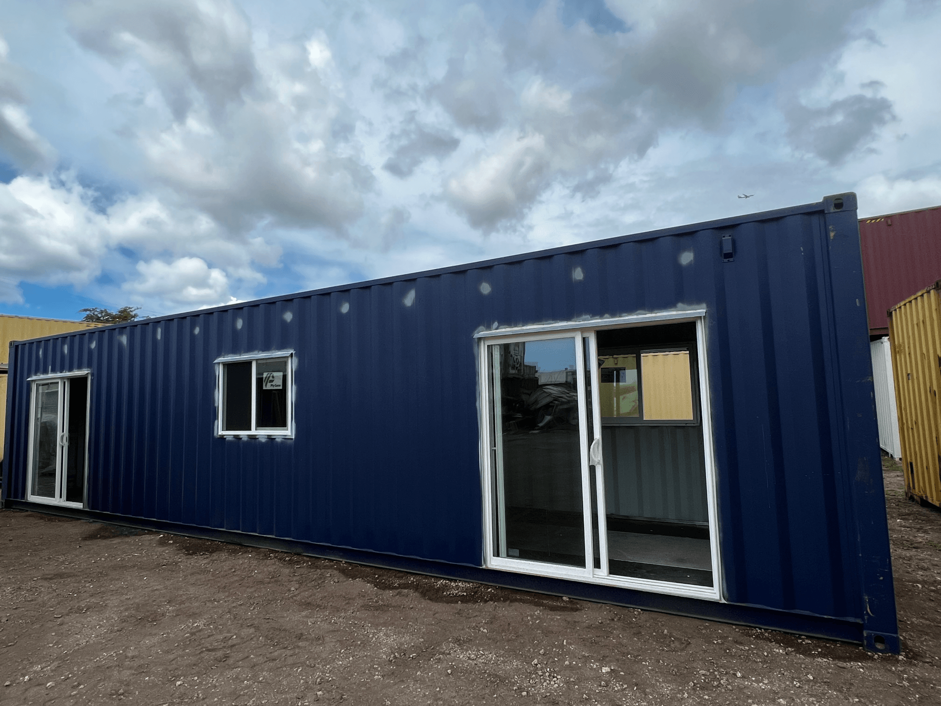 40 ft Custom Shipping Container Space with sliding door, window and dark blue exterior