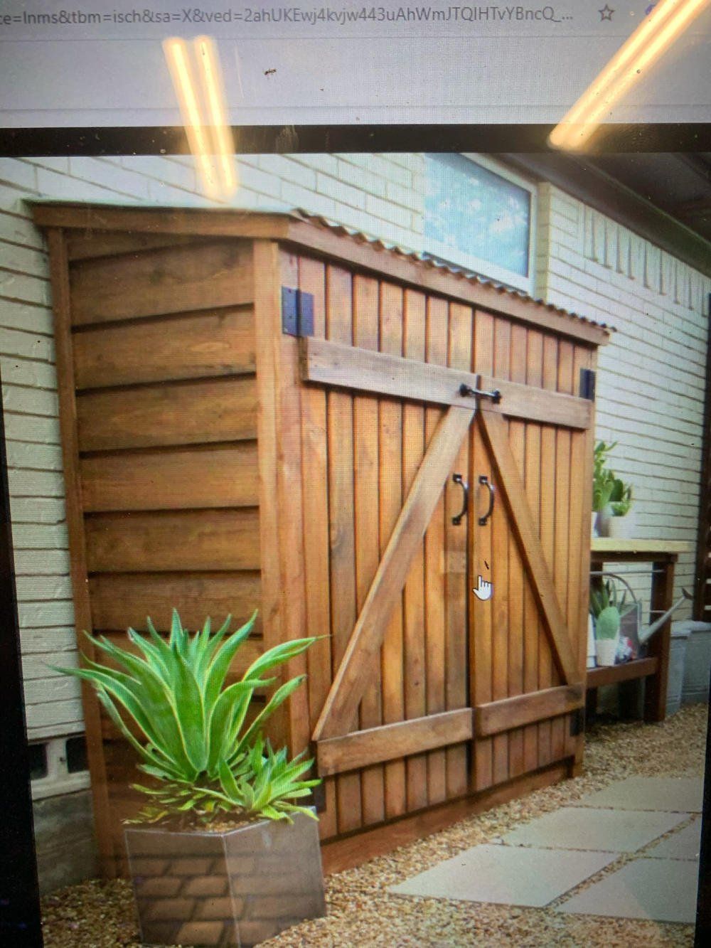Studio Shed exterior with custom wood decor