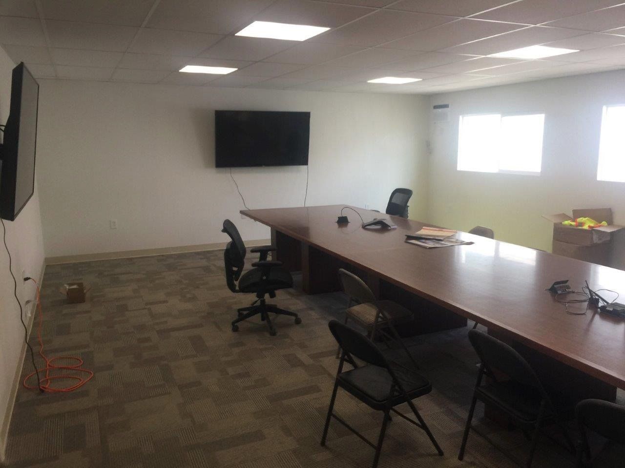 Multiple-Wide Office and Custom Space with large meeting table and media display