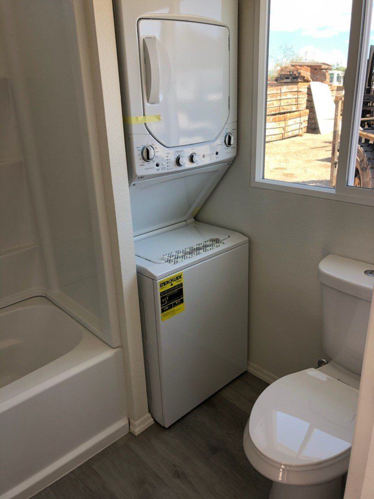 Custom Shipping Container Interior with custom bathroom with washer and dryer