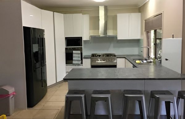 A Kitchen With White Cabinets and a Black Refrigerator — GC Joinery in Sunshine Acres, QLD
