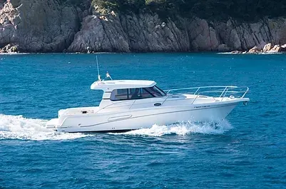 Un barco blanco flota sobre una gran masa de agua.