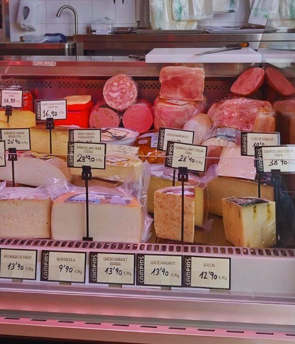 Una vitrina llena de diferentes tipos de queso.