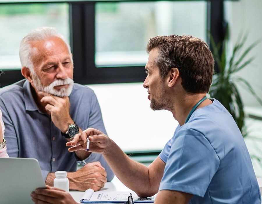 Doctor talking with a patient in a bright clinic, gesturing during a consultation
