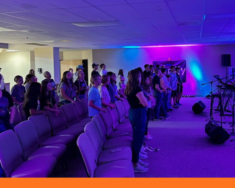 First Baptist students standing during Wednesday worship time