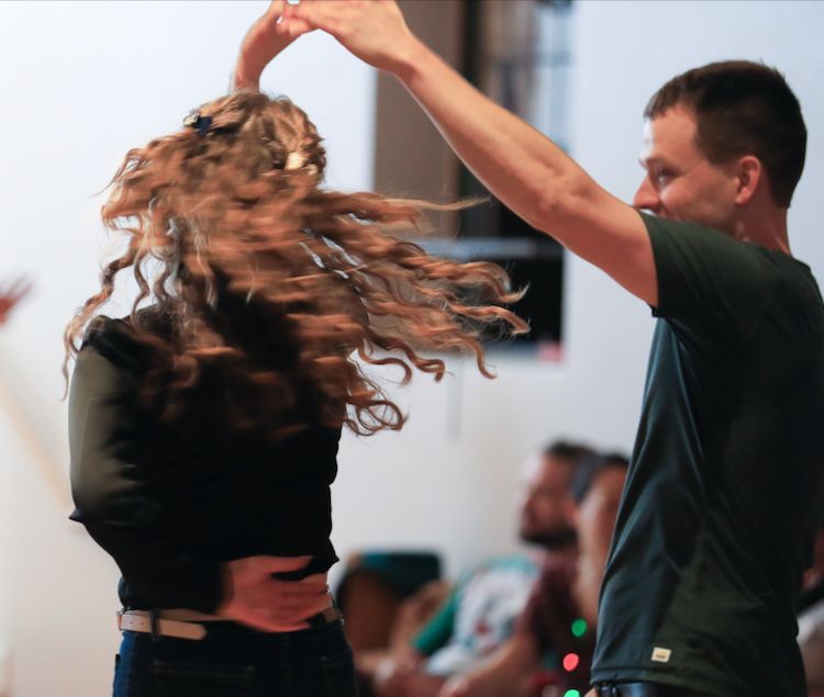 a woman being spinned on the dance floor