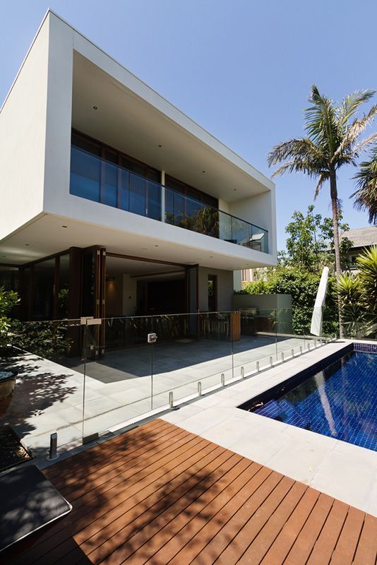 A Large White House With a Swimming Pool in Front of It — Glen Lamberts Wall Cladding & Home Improvements in Pampoolah, NSW