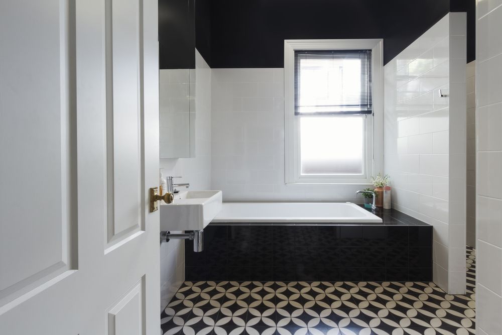 A Bathroom With a Bathtub, Sink and Window — Glen Lamberts Wall Cladding & Home Improvements in Raymond Terrace, NSW