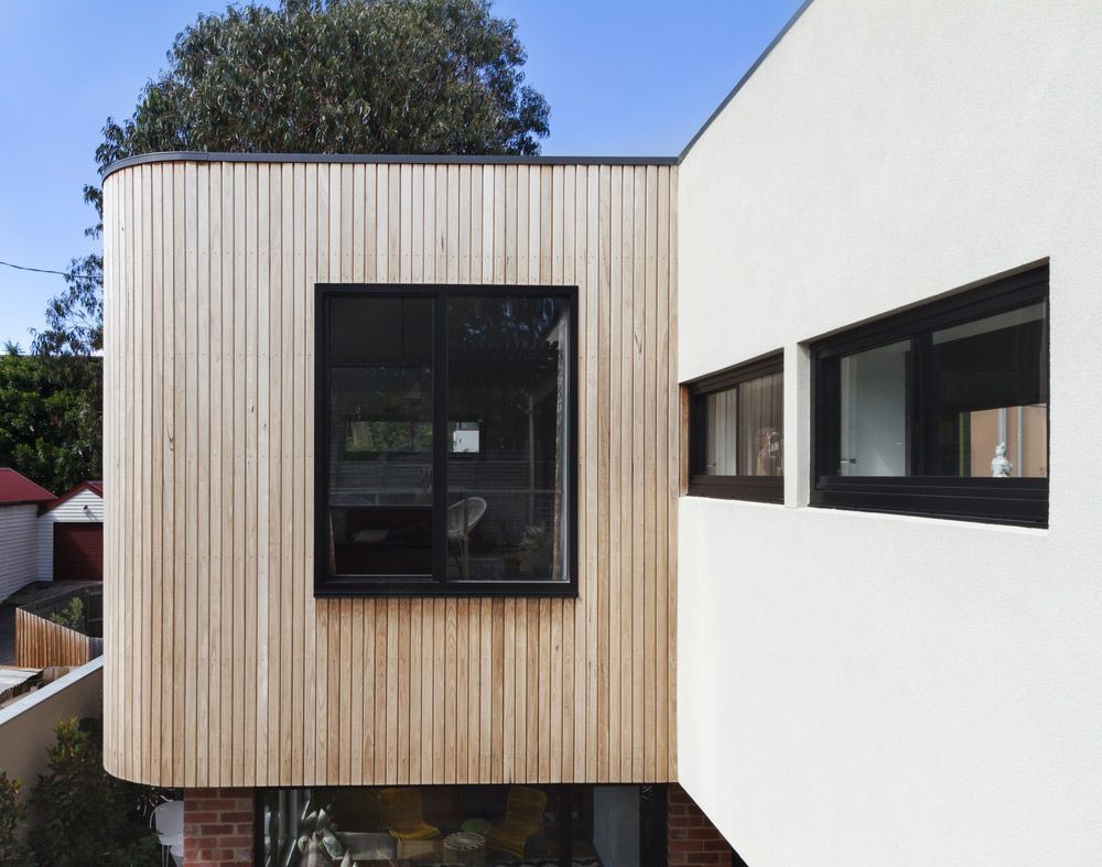 A White House With a Wooden Siding and Black Windows — Glen Lamberts Wall Cladding & Home Improvements in Taree, NSW