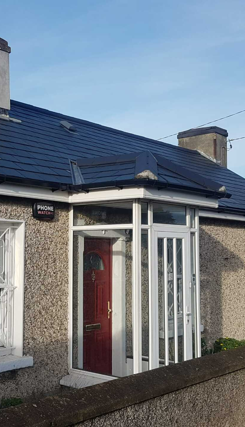 A house with a red door and a blue roof.