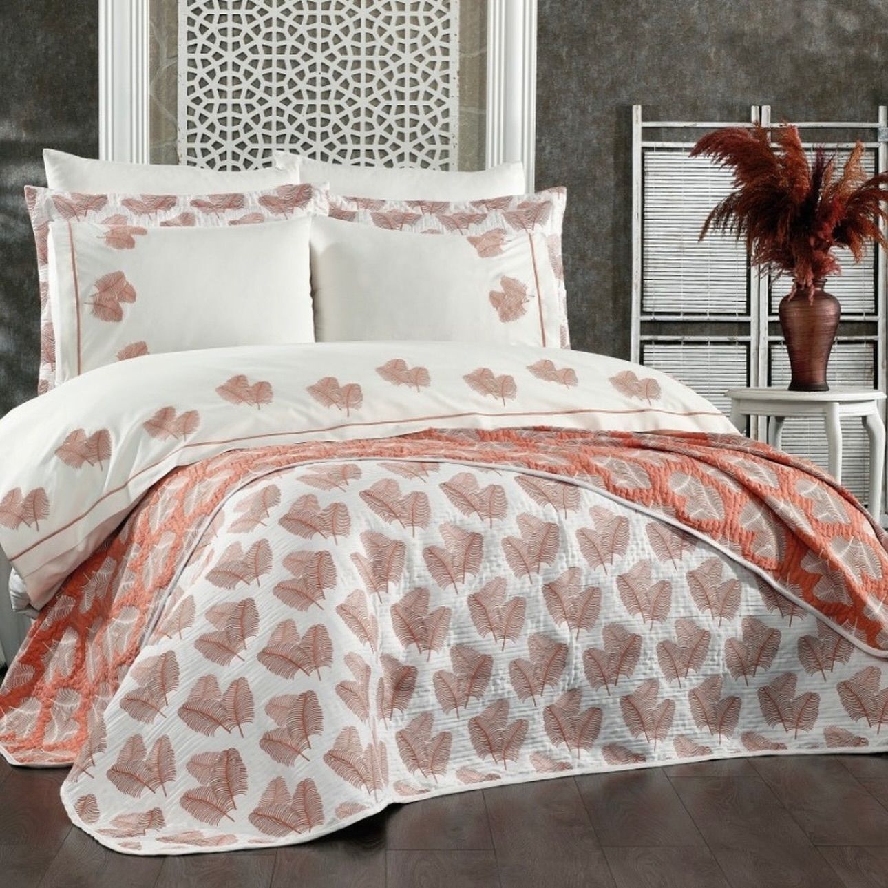 A bed with a quilt and pillows on it