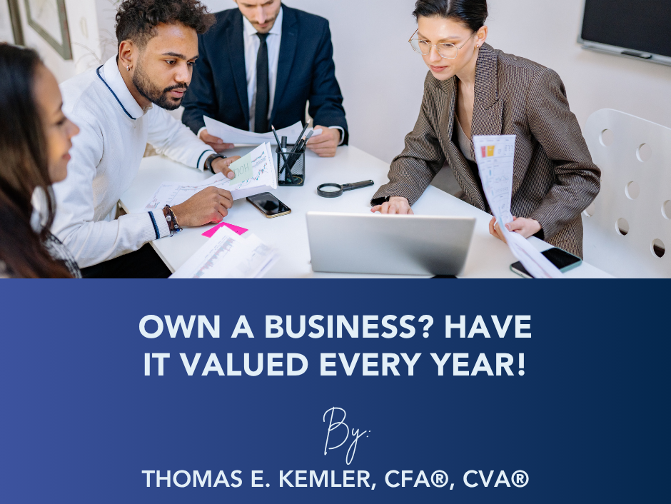 Business team in a meeting over documents with banner: “Own a business? Have it valued every year!”
