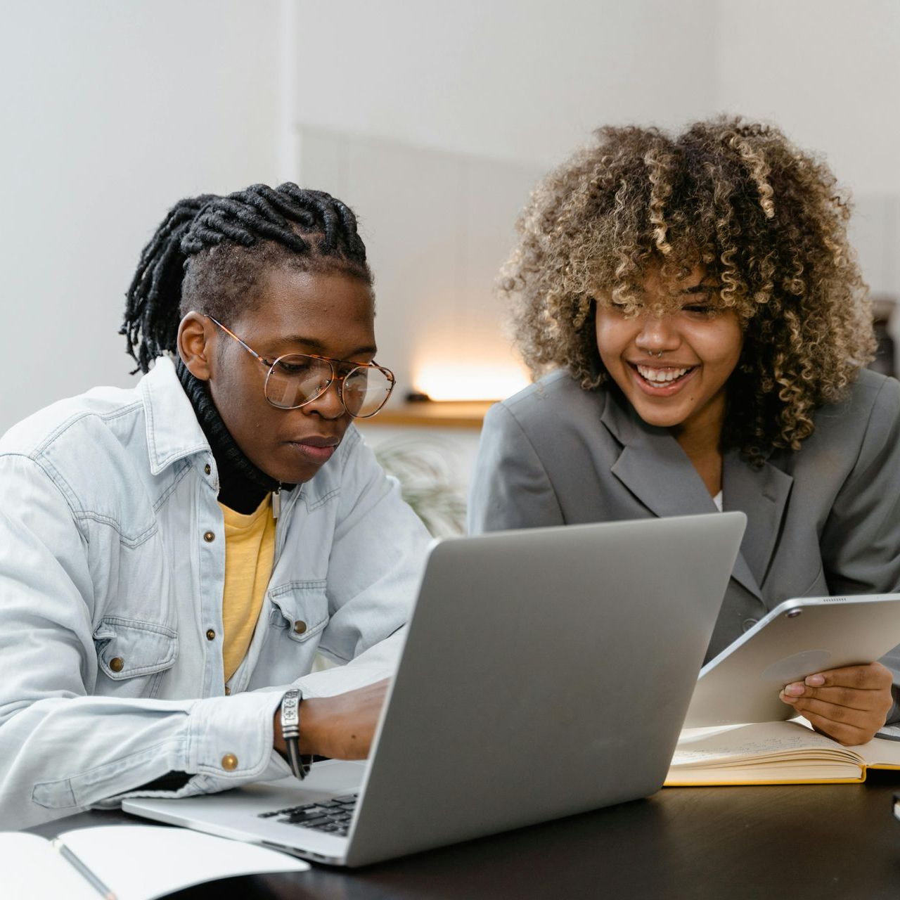 two people looking at a laptop
