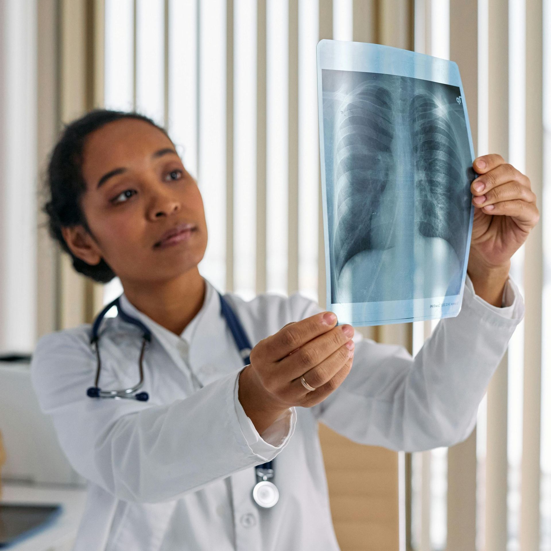 medical professional looking at an xray scan