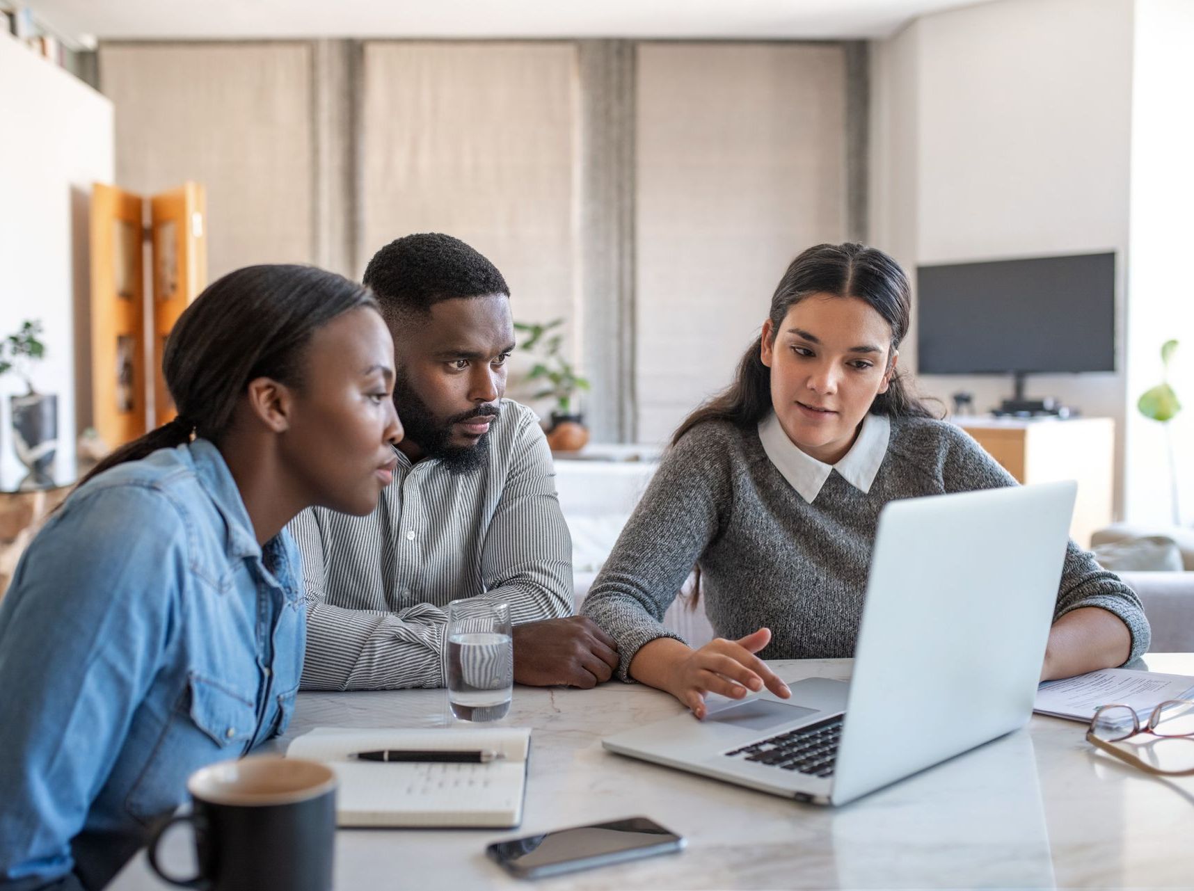 stock image of a group of employees looking at a laptop