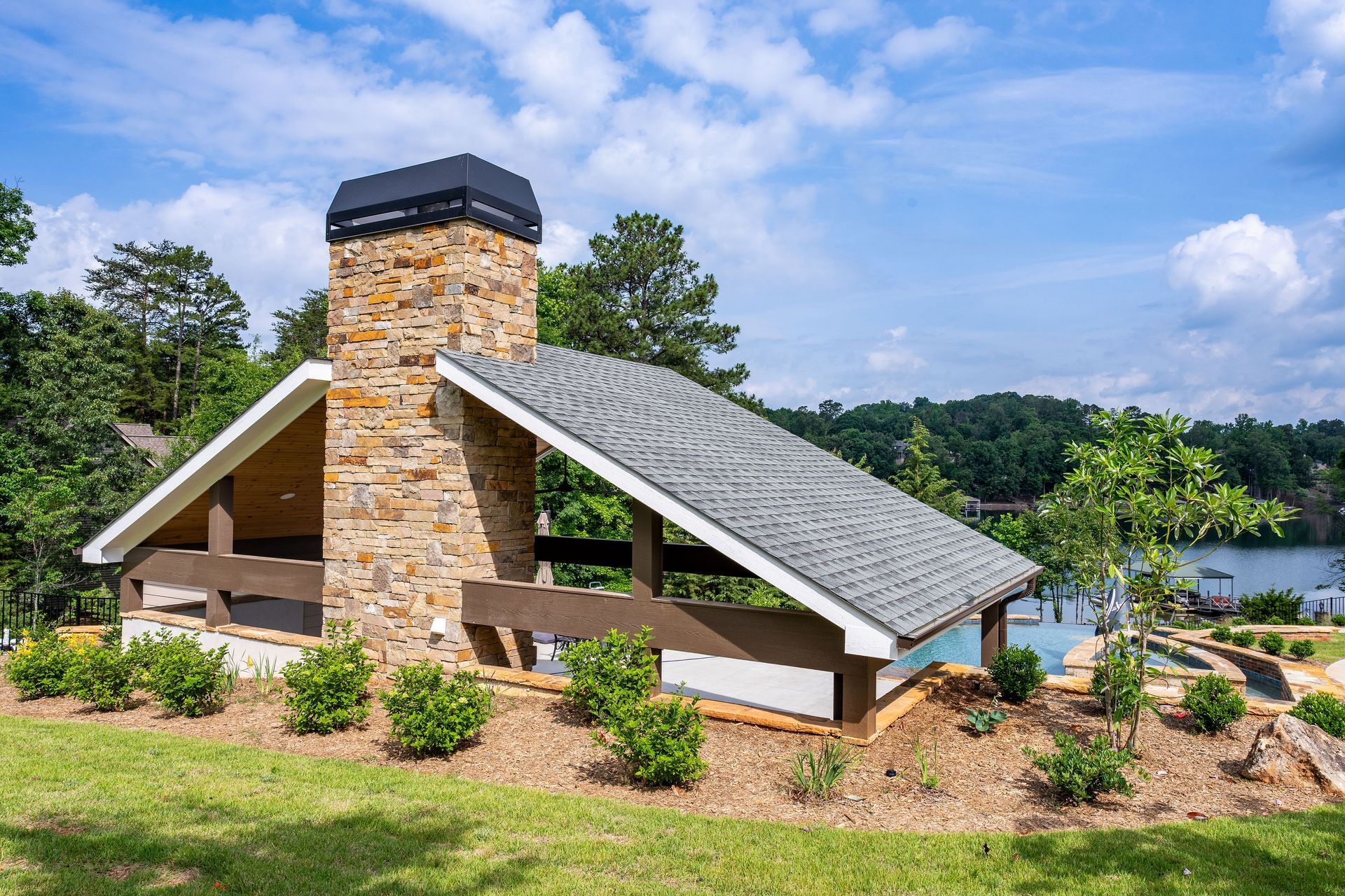 Pavilion with stone fireplace, outdoor kitchen overlooking Lake Keowee