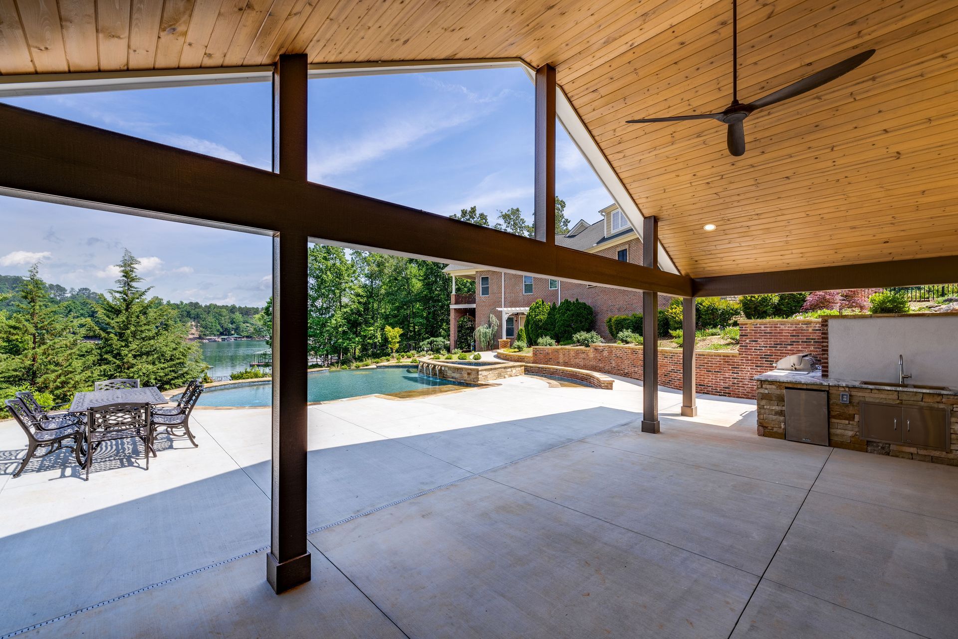 Pavilion with tongue and groove ceiling overlooking gunite pool and Lake Keowee