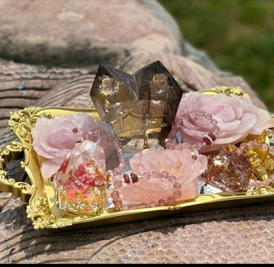 Assorted colorful crystals and geodes on a white fabric background.