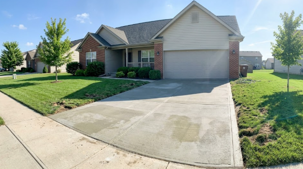 Freshly poured concrete driveway outside a Rockingham County home.