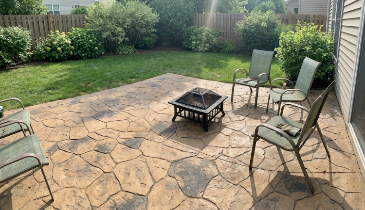 Stamped concrete patio with a flagstone pattern and outdoor seating.